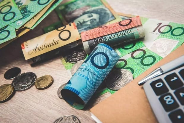 Investment Advice Mackay - Australian banknotes and coins scattered on a table – Financial advice for managing Australian currency, budgeting, and growing personal wealth.