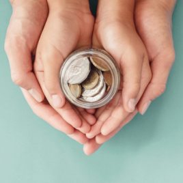 Hands holding jar of money_sq