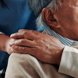 Elderly man, hand on shoulder with carer_sq